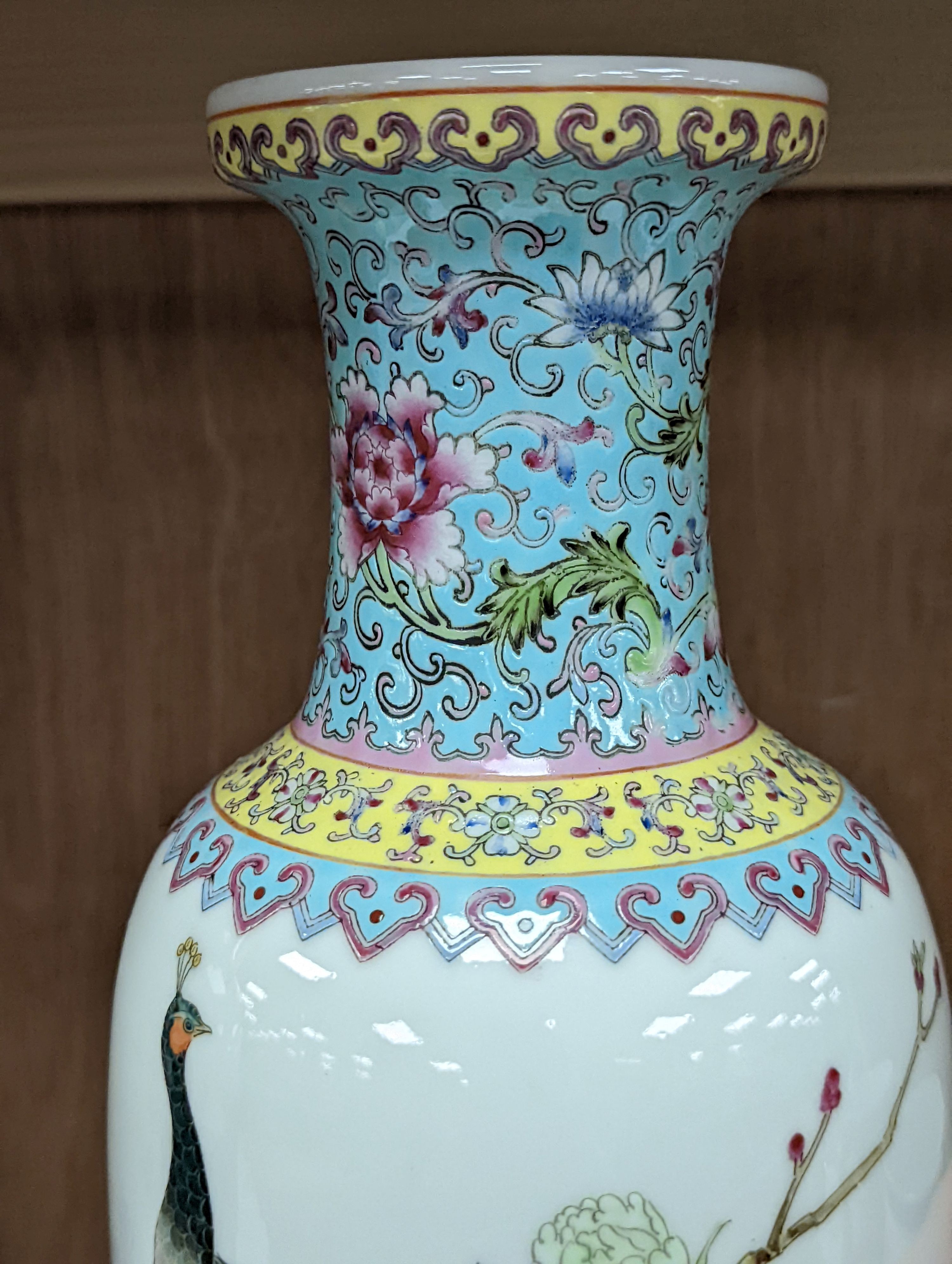 A pair of Chinese famille rose vases decorated with peacocks, 31cm